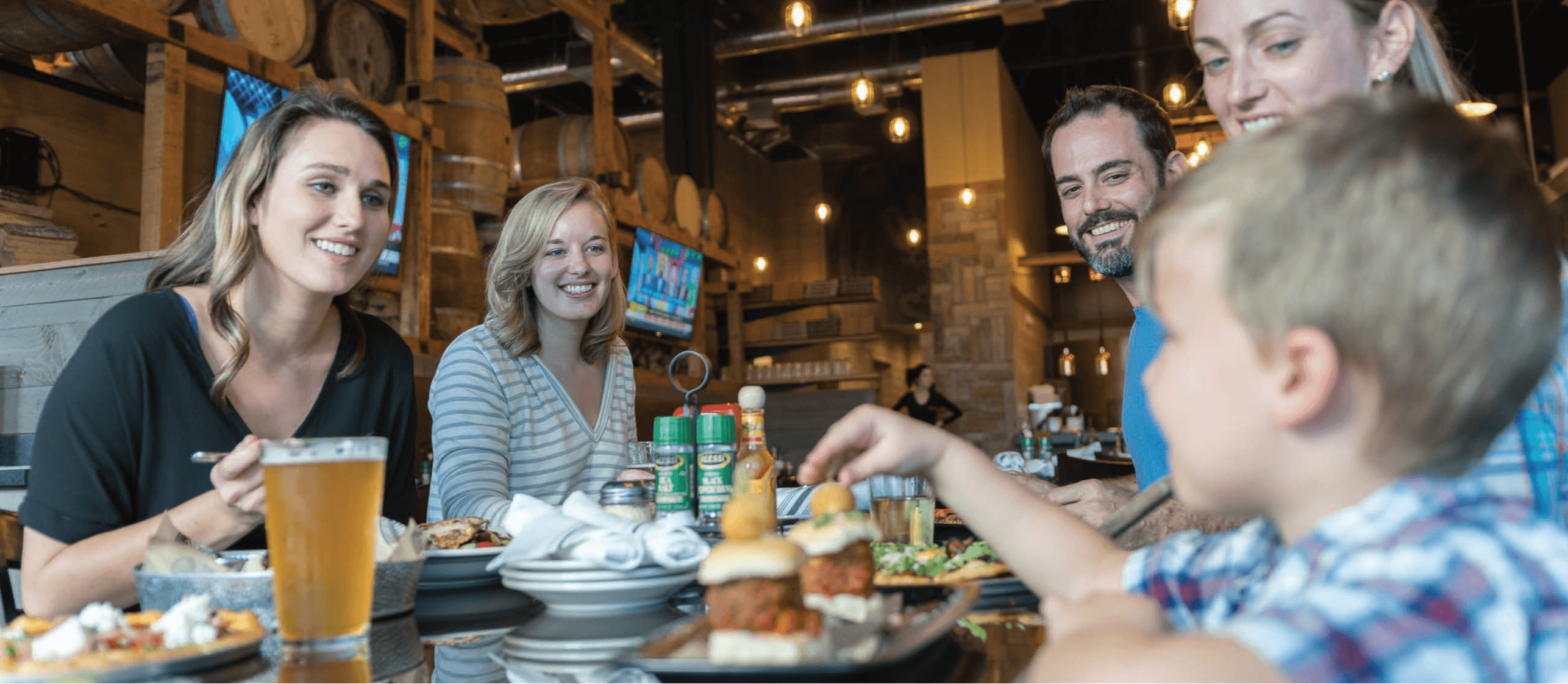 Family sitting around a restaurant table eating